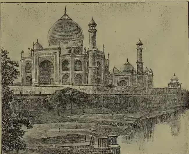 A detailed black and white photograph of the Taj Mahal in Agra. The image shows the iconic white marble mausoleum with its large central dome and four smaller domes at the corners. Four tall, slender minarets rise from the corners. The building is set on a raised platform and is surrounded by a wall. In the foreground, there is a body of water, likely the Yamuna River, with some trees and a small structure visible on the bank.