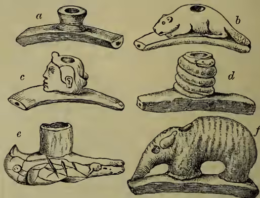 Figure 3: Mound Pipes. Six carved stone pipes labeled a through f. a: 'monitor' pipe, a simple bowl-shaped pipe. b: beaver pipe, carved in the shape of a beaver. c: pipe carved in the form of a human head. d: serpent pipe, a pipe with a coiled serpent design. e: bird pipe, a pipe with a bird design. f: elephant pipe, a pipe carved in the shape of an elephant.
