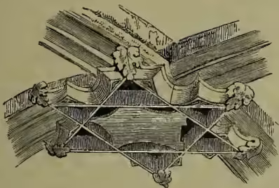 A detailed woodcut-style illustration of a boss, which is a decorative element in a vaulted ceiling. It features a central circular motif surrounded by radiating lines and intricate patterns, including what appears to be a small animal or figure within the design.