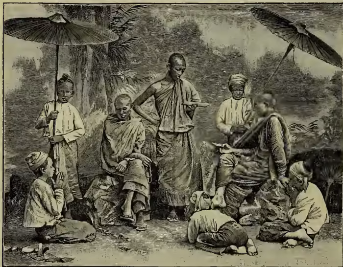 A black and white illustration depicting a group of Buddhist monks and their pupils in an outdoor setting. Several monks are seated on the ground, some wearing traditional robes and headgear. One monk is standing and holding a large, open umbrella. Another monk is seated and appears to be reading or writing. A few other figures, possibly pupils, are also present, some sitting and some standing. The background shows a simple landscape with trees and a distant structure.