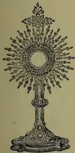 A detailed black and white illustration of a monstrance, a Catholic religious vessel. It features a central circular host holder (lunula) surrounded by numerous thin, radiating rays, resembling a sun or star. The entire structure is mounted on a tall, ornate cylindrical stand with decorative carvings and a wide, tiered base.