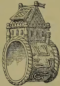 A detailed black and white illustration of a large, ornate ring. The ring has a thick, textured band and a large, circular, slightly recessed setting. The setting is decorated with intricate patterns and a small, stylized figure or emblem in the center. The ring is shown from a three-quarter perspective, highlighting its depth and craftsmanship.