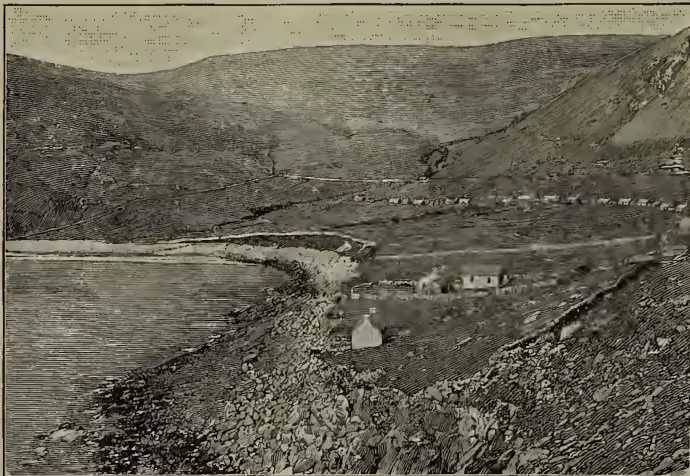 A black and white illustration of the town and bay of St Kilda. The scene shows a rugged coastline with steep cliffs on the right and a calm bay on the left. Several small buildings are scattered along the shore and on a small peninsula. The water is calm, and the sky is clear.