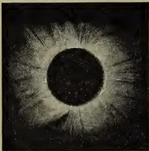 A black and white photograph showing a total solar eclipse. A dark, circular disk of the Moon is centered, completely obscuring the Sun's disk. Surrounding the Moon's edge is a bright, glowing ring of light, known as the solar corona. The corona appears wispy and textured, with some darker, more solid-looking regions. The background is a dark, starry sky.